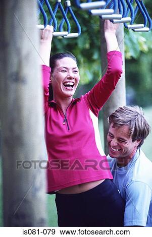 Couple on obstacle course View Large Photo Image Stock Photo - Couple on obstacle course. Fotosearch