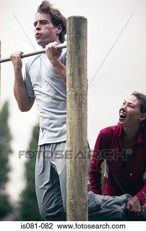Stock Image - Man doing pull-ups. Fotosearch