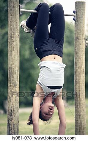 Woman hanging from bar View Large Photo Image Stock Photo - Woman hanging from bar. Fotosearch