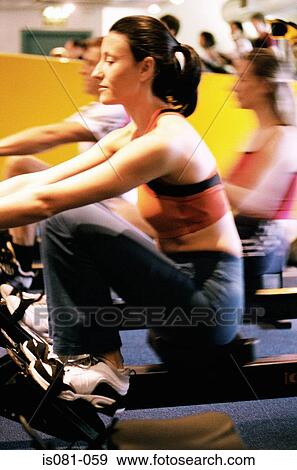 Woman on rowing machine View Large Photo Image Stock Photo - Woman on rowing machine. Fotosearch