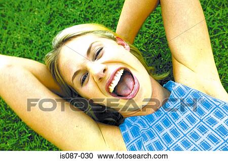 Stock Image - Girl lying on grass. Fotosearch