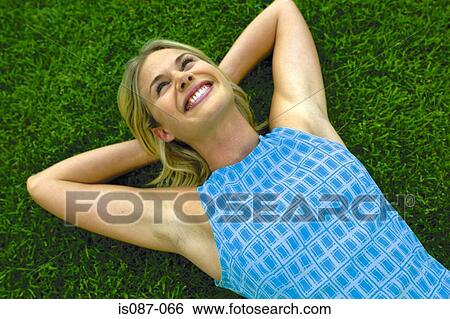 Girl lying on grass View Large Photo Image Stock Photograph - Girl lying on grass. Fotosearch