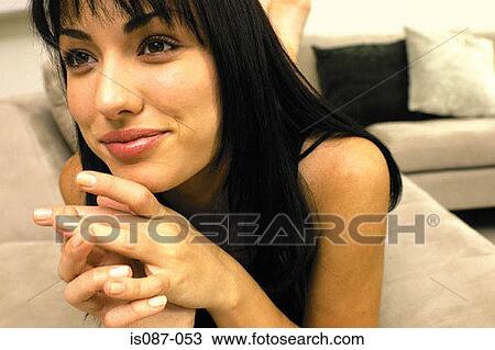 Stock Image - Girl lying on sofa. Fotosearch