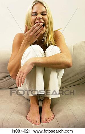 Girl sitting on sofa View Large Photo Image Stock Image - Girl sitting on sofa. Fotosearch
