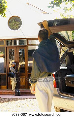 Couple leaving a house View Large Photo Image Stock Photo - Couple leaving a house. Fotosearch