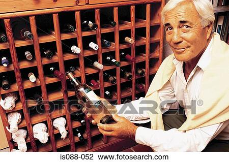 Stock Image - Man choosing wine. Fotosearch