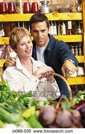 Man and woman buying food View Large Photo Image Stock Photo - Man and woman buying food. Fotosearch