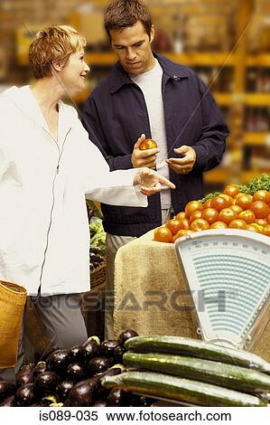Stock Photography - Man and woman buying food. Fotosearch