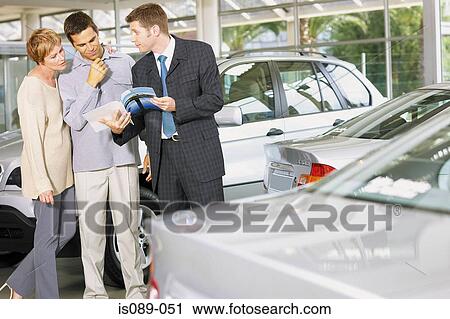 Stock Image - Man and woman choosing a car. Fotosearch