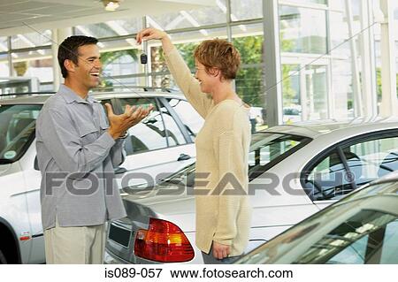 Stock Photo - Man and woman choosing a car. Fotosearch