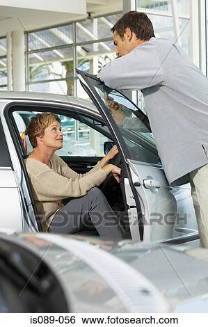 Man and woman choosing a car View Large Photo Image Stock Photograph - Man and woman choosing a car. Fotosearch
