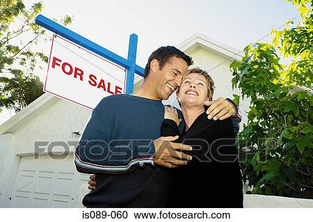 Stock Image - Man and woman choosing a house. Fotosearch