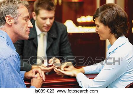 Stock Image - Man and woman choosing jewellery. Fotosearch