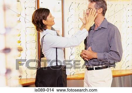 Picture - Man and woman choosing spectacles. Fotosearch