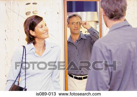 Man and woman choosing spectacles View Large Photo Image Stock Image - Man and woman choosing spectacles. Fotosearch