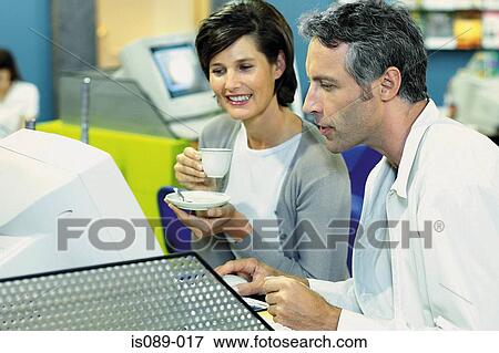 Stock Photo - Man and woman in travel agent. Fotosearch