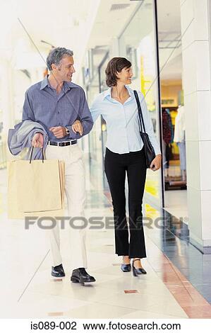 Stock Image - Man and woman window shopping. Fotosearch