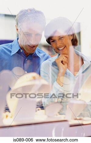 Man and woman window shopping View Large Photo Image Stock Photograph - Man and woman window shopping. Fotosearch