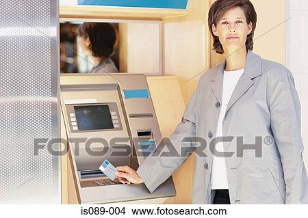 Picture - Woman at cashpoint. Fotosearch