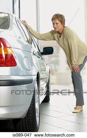 Woman choosing a car View Large Photo Image Stock Photo - Woman choosing a car. Fotosearch