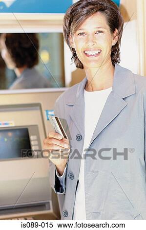Stock Photography - Woman withdrawing cash. Fotosearch