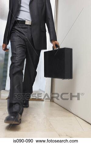 Stock Image - Businessman in corridor . Fotosearch