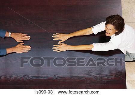 Stock Image - Man and woman at a table. Fotosearch