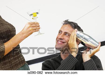 Man and woman having a cocktail View Large Photo Image Stock Image - Man and woman having a cocktail. Fotosearch