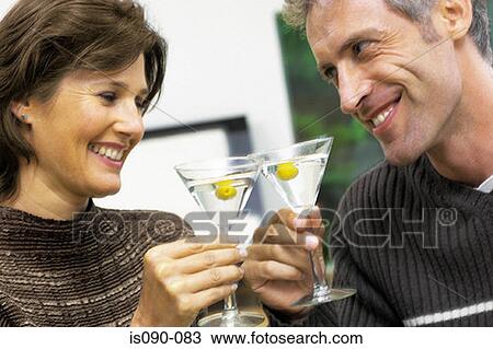 Stock Image - Man and woman having a cocktail. Fotosearch