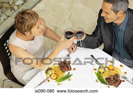 Stock Image - Man and woman having a romantic meal. Fotosearch