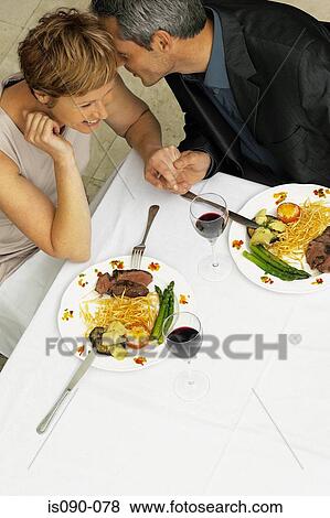 Stock Photo - Man and woman having a romantic meal. Fotosearch