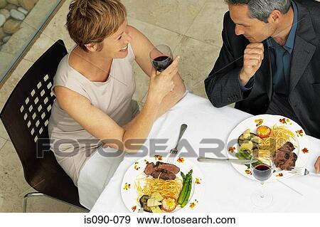Man and woman having a romantic meal View Large Photo Image Stock Photo - Man and woman having a romantic meal. Fotosearch
