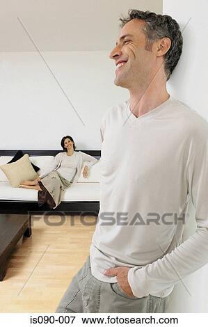 Stock Photo - Man and woman in sitting room. Fotosearch