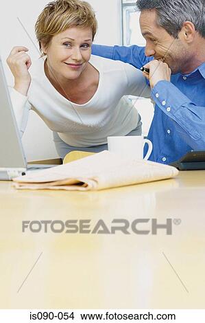 Picture - Man and woman working together. Fotosearch