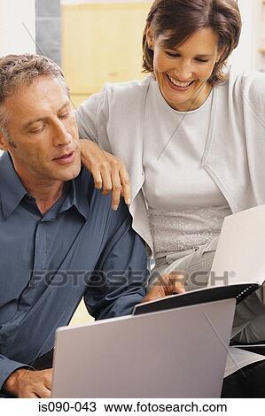Stock Image - Man and woman working together. Fotosearch