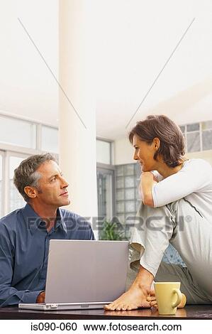 Stock Image - Man and woman working together. Fotosearch