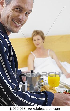 Man delivering breakfast in bed View Large Photo Image Stock Photo - Man delivering breakfast in bed. Fotosearch