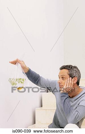 Man holding a goldfish View Large Photo Image Stock Photo - Man holding a goldfish. Fotosearch