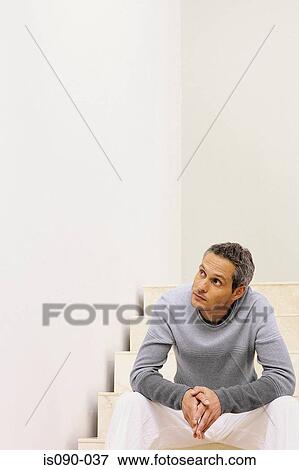 Man sitting on staircase View Large Photo Image Stock Photo - Man sitting on staircase. Fotosearch