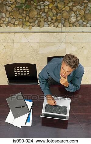 Picture - Man working on laptop computer. Fotosearch