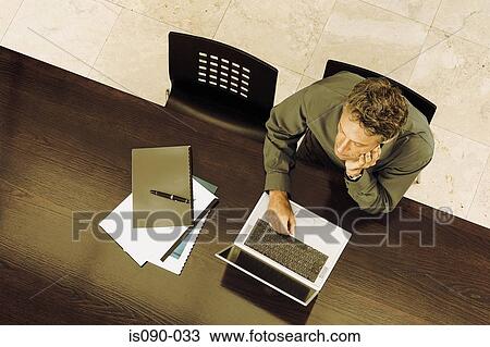 Stock Image - Man working on laptop computer. Fotosearch