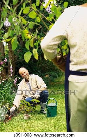 Stock Image - Couple in a garden. Fotosearch