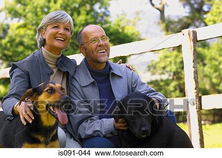 Couple with dogs View Large Photo Image Picture - Couple with dogs. Fotosearch