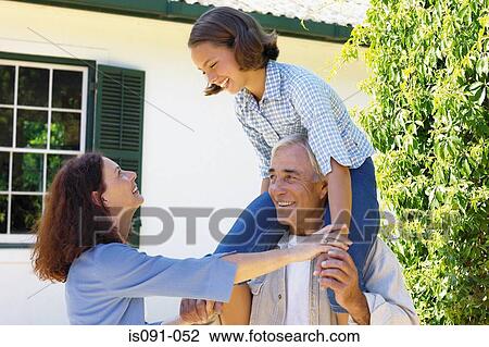 Stock Image - Grandparents and granddaughter. Fotosearch