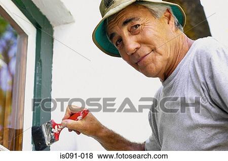 Stock Photo - Man painting house. Fotosearch
