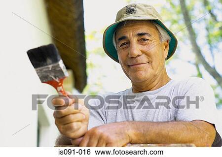 Stock Photograph - Man painting house. Fotosearch