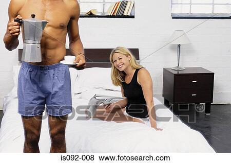 Couple having coffee in bed View Large Photo Image Stock Photo - Couple having coffee in bed. Fotosearch