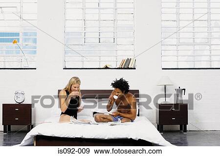 Couple having coffee in bed View Large Photo Image Stock Photo - Couple having coffee in bed. Fotosearch