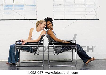 Couple playing on chairs View Large Photo Image Stock Photo - Couple playing on chairs. Fotosearch