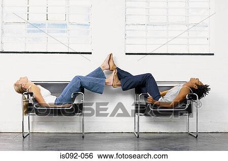 Couple playing on chairs View Large Photo Image Stock Photograph - Couple playing on chairs. Fotosearch